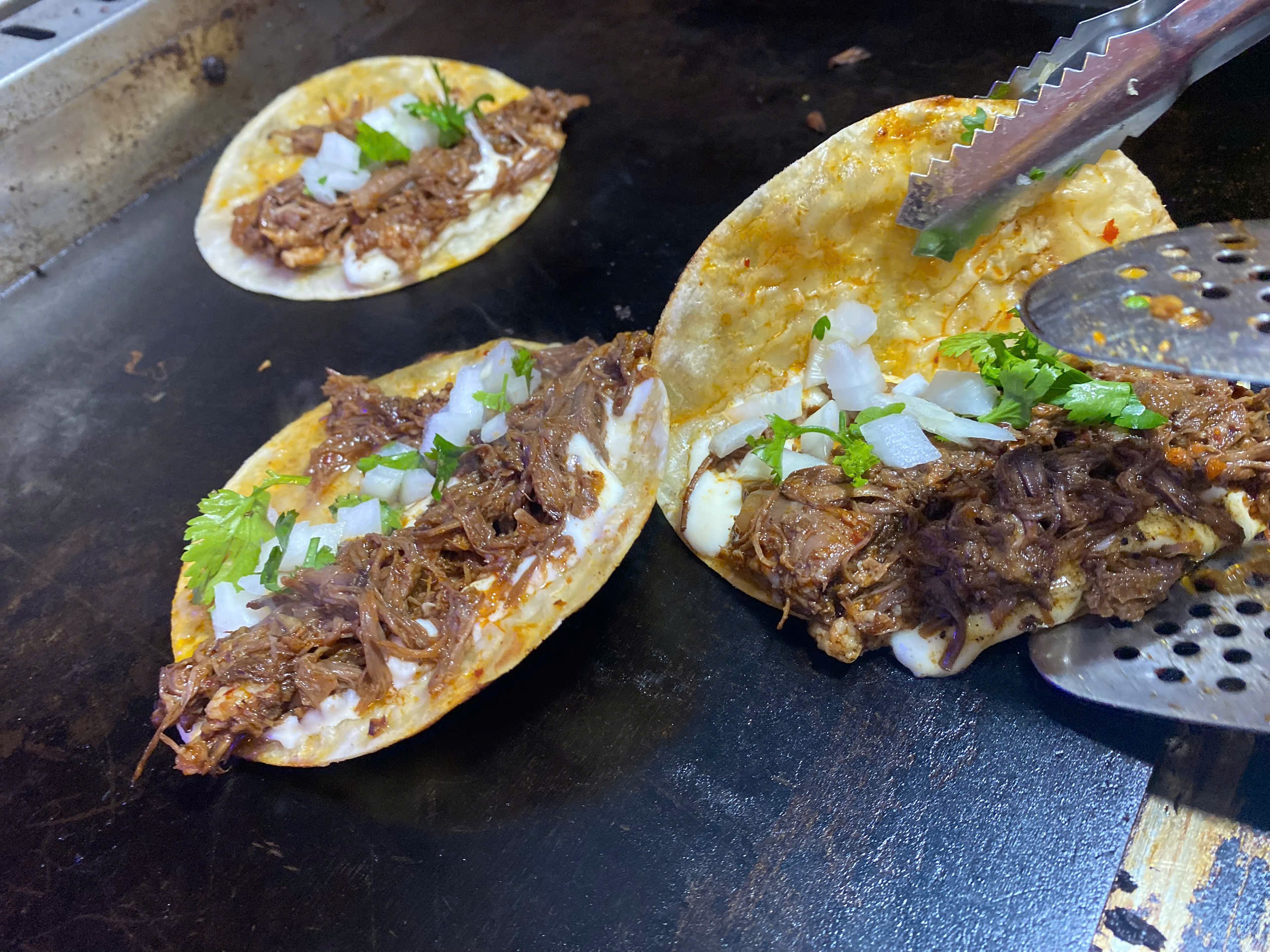 Hands grabbing taco